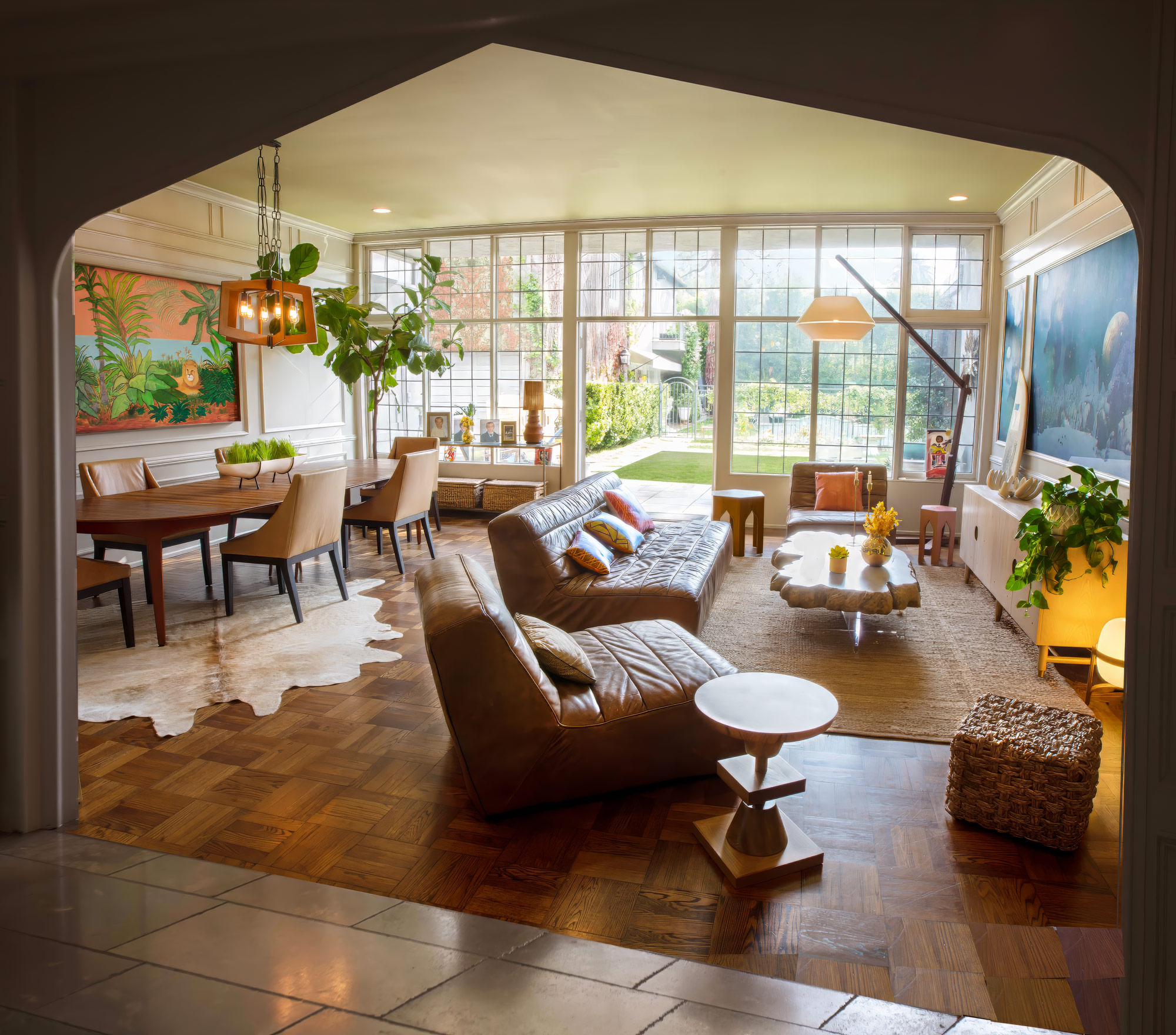 “Feng shui interior designer Los Angeles — sunlit living and dining room framed by an archway”