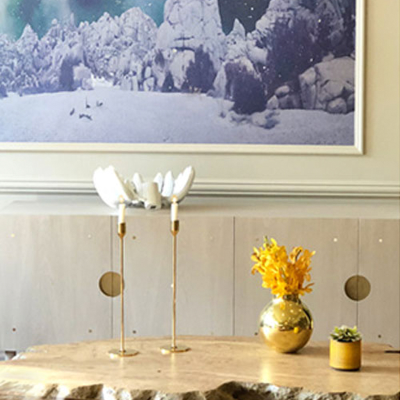 Residential interior design by Kim Colwell — live-edge table styled with brass candlesticks and gold vase. Biophilic elements like a live edge coffee table and cloud like wallpaper make a personal connection to the client. 
