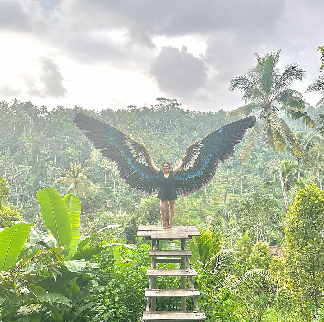 Kim Colwell portrait with feathered wings that symbolize the flight into future goals, the cornerstone intention for her House Blessing Ceremony's held in Los Angeles for private clients. 